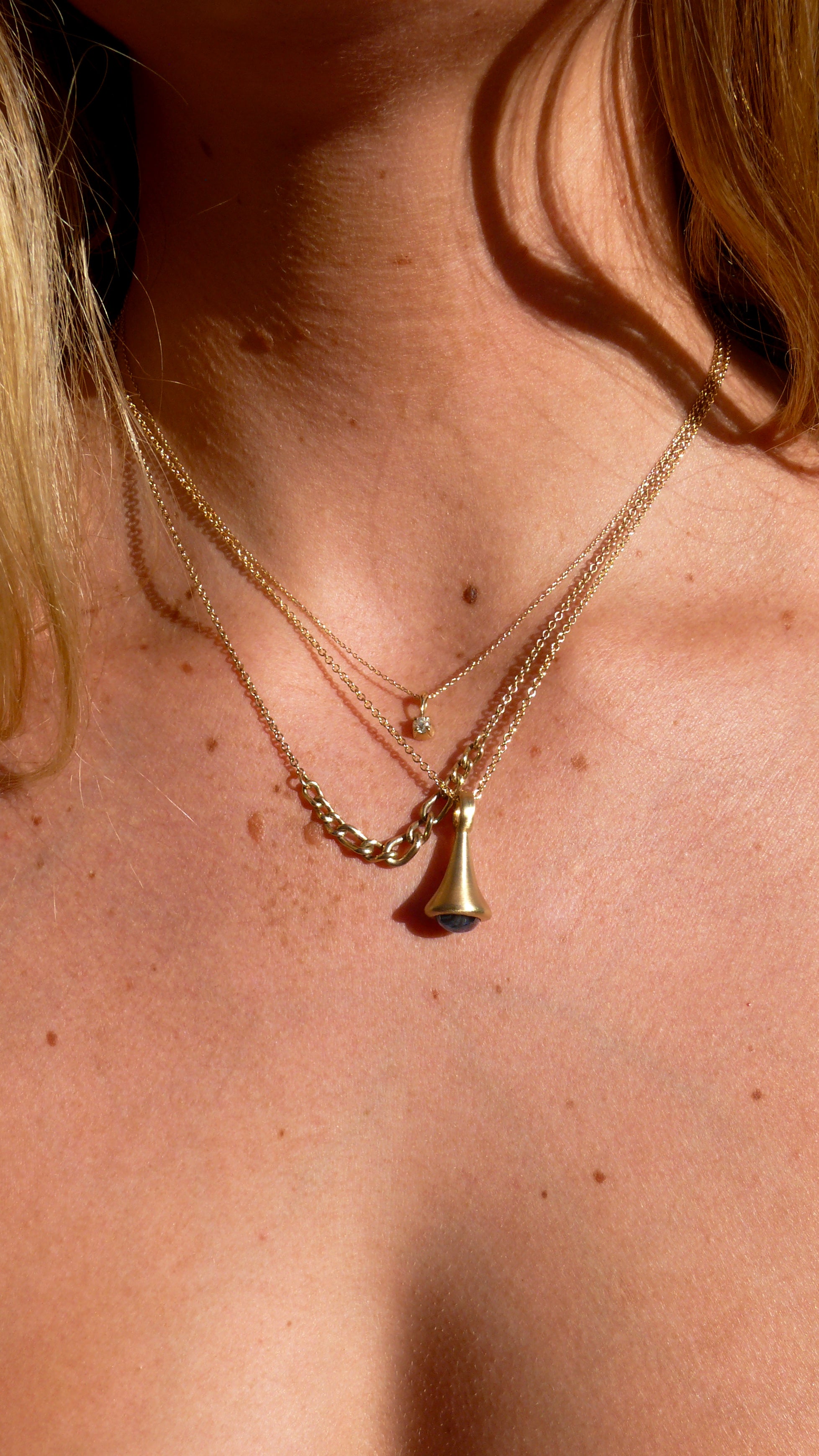 One-of-a-Kind Gold Blue Sapphire Pendulum Charm No. 2, and diamond blossom charm, and graduated curb chain necklace on model 