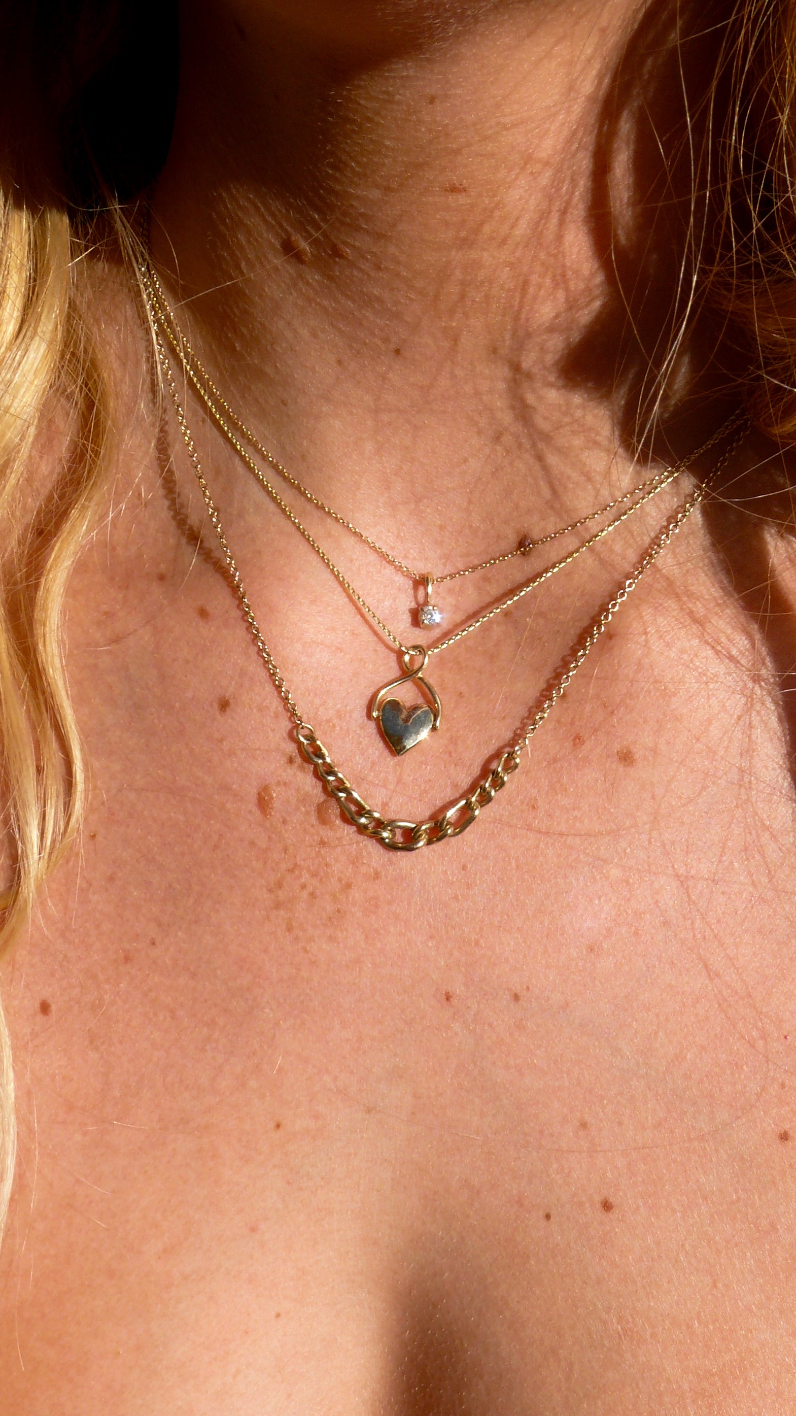 Gold Spinning Heart Charm, Diamond Charm, and Curb Chain Necklace on model