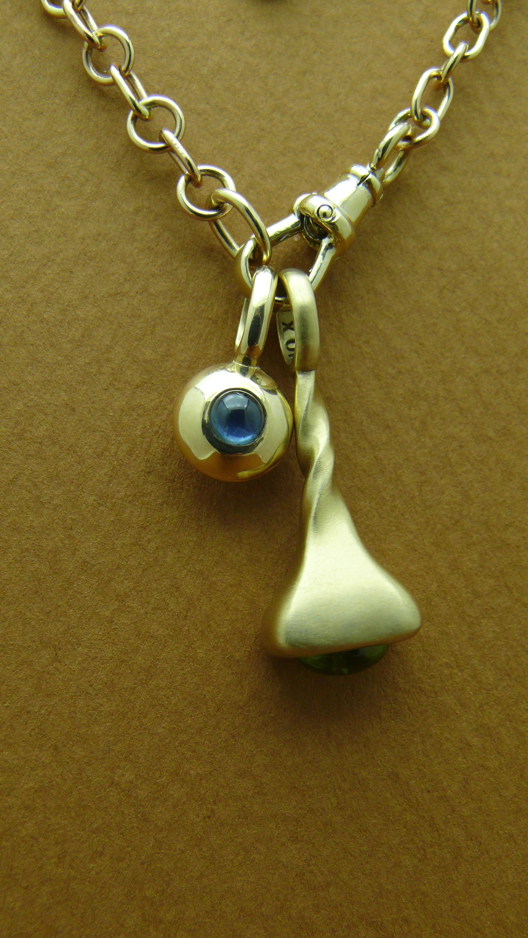 Sapphire-Diamond-Reflection-Charm-on fairmined gold rhythm chain with okay fine periot pendulum charm