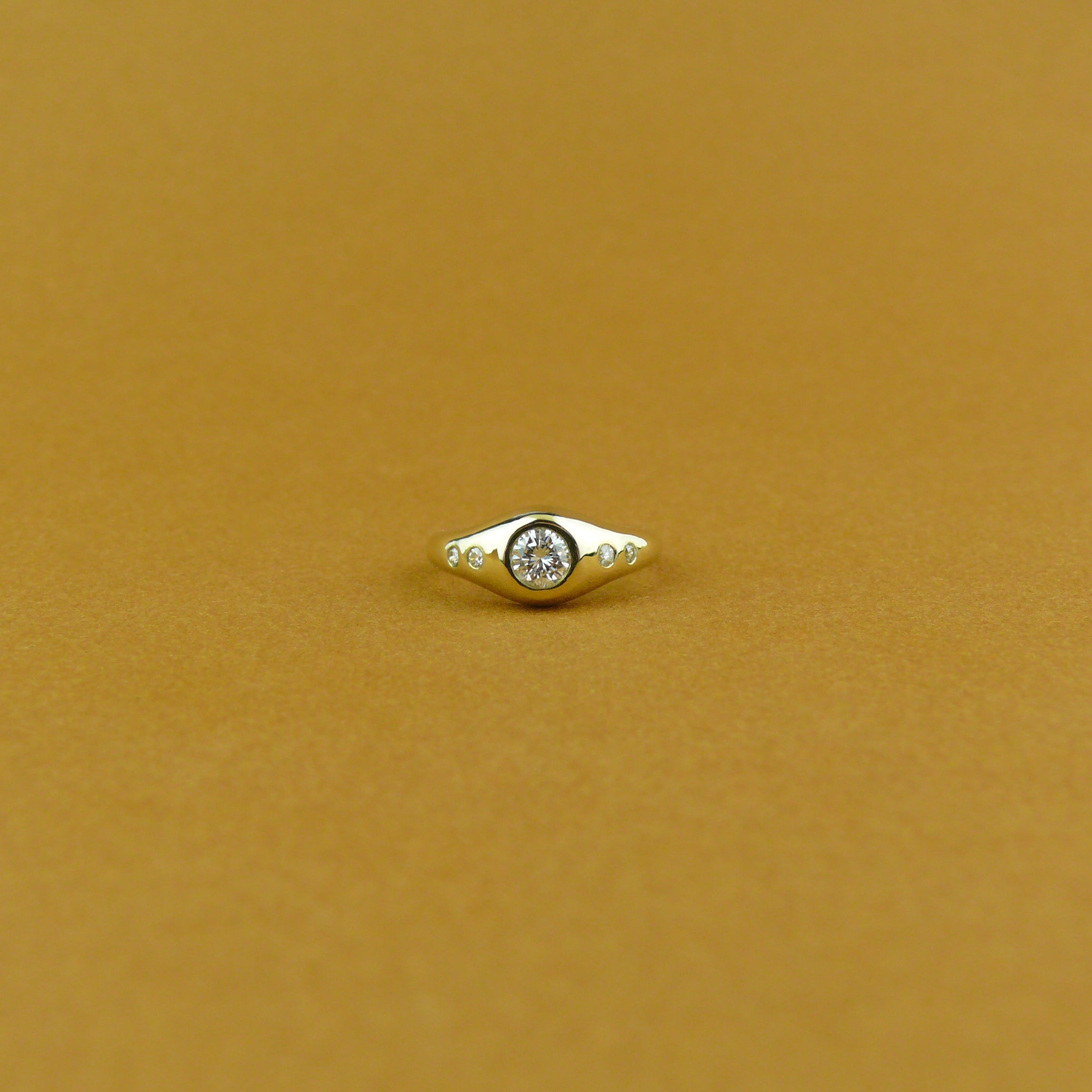 Custom gold flush set diamond signet ring