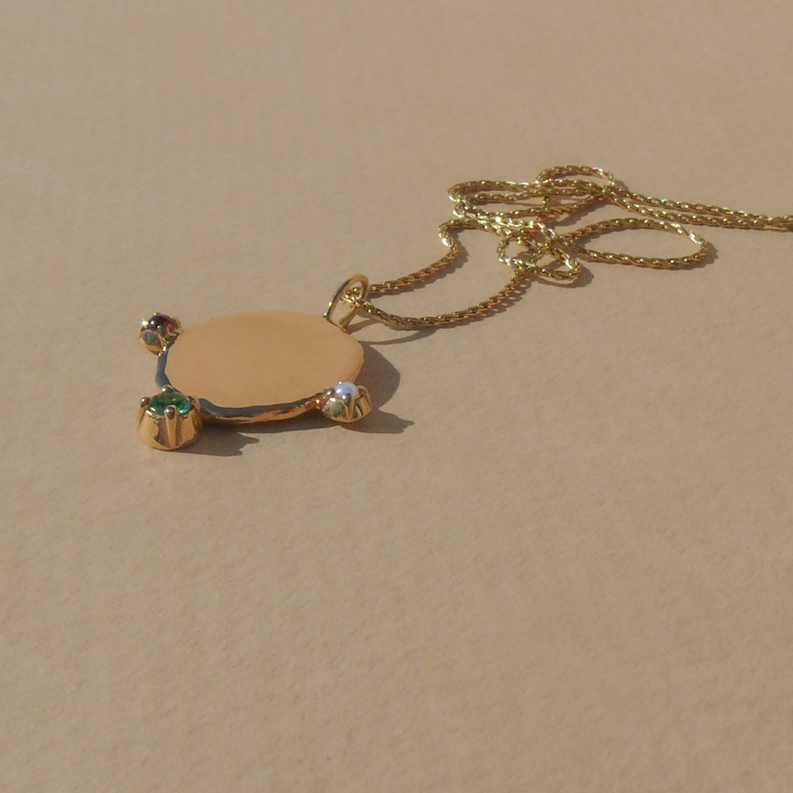 Gold large blossom medallion with emerald, ruby, and pearl