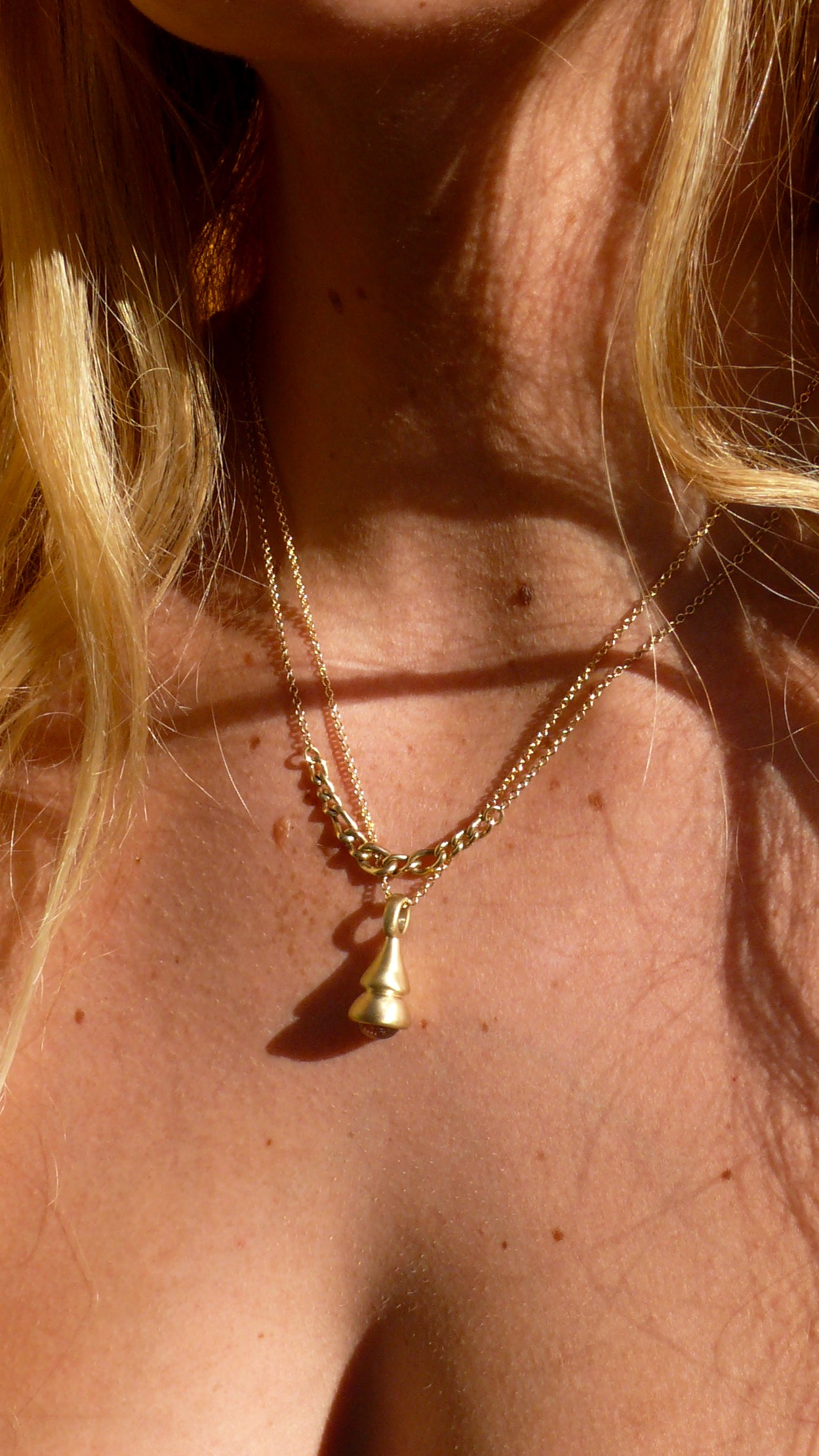 One-of-a-Kind Gold Pink Tourmaline Pendulum Charm No. 1  on model with the Graduated Curb Chain Necklace