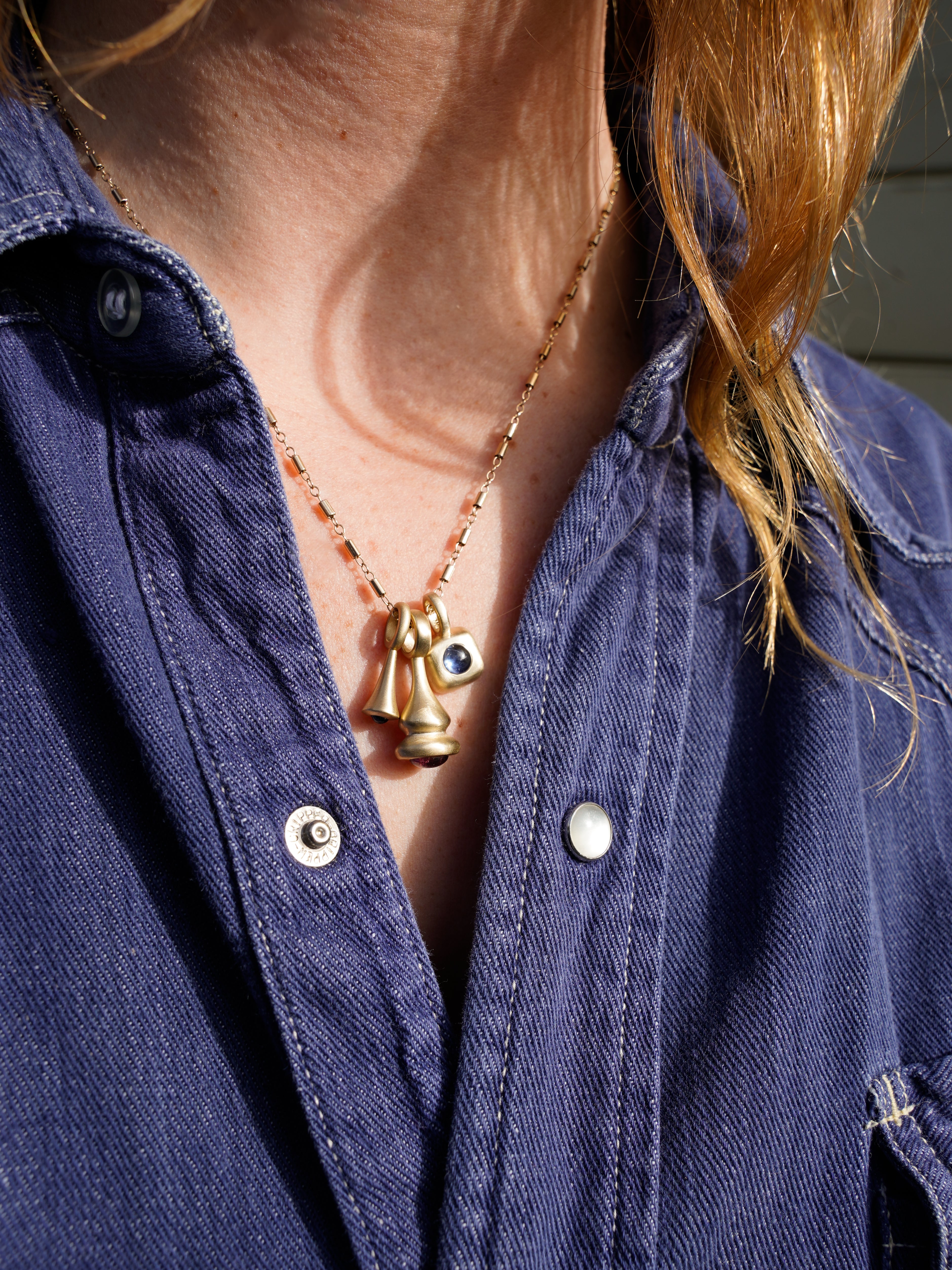 Blue Sapphire Trove Charm and Pendulum Charms-Gold on model with denim shirt