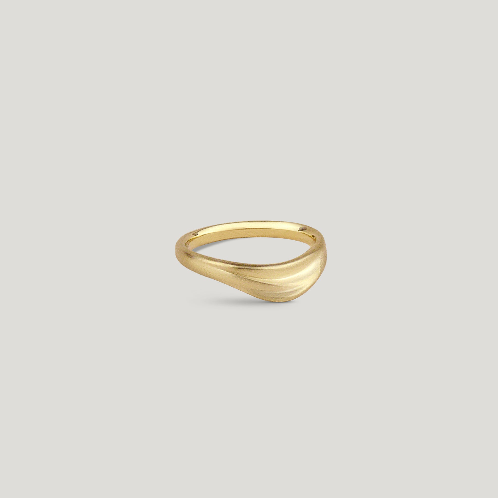 Curved dune gold wedding ring with organic texture