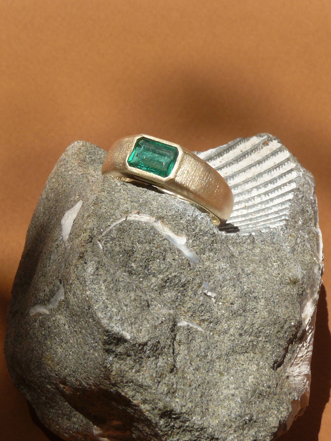 Emerald Cut emerald gold signet ring with matte finish on shell