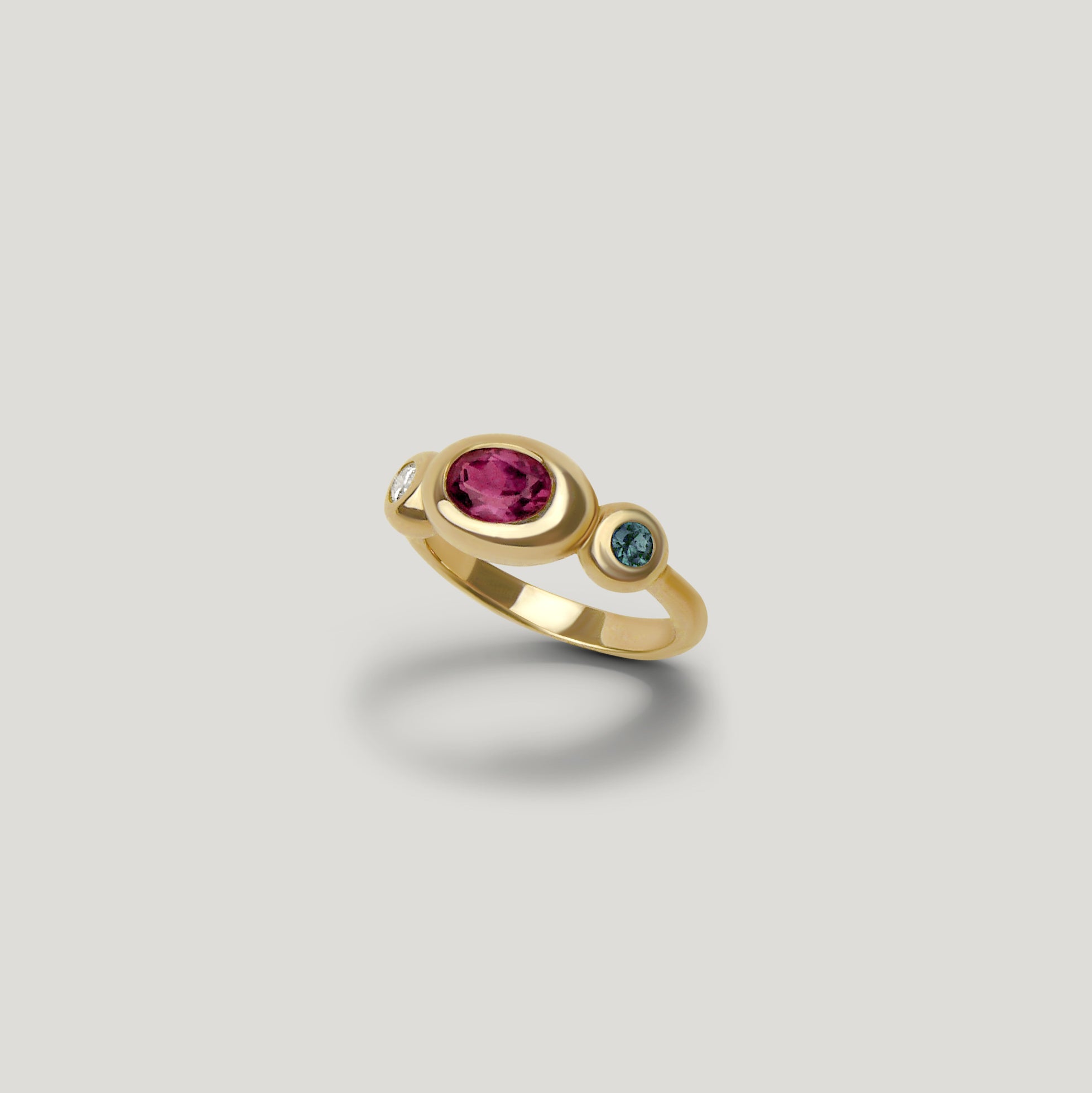 Foundation Trio Ring with garnet, teal sapphire, and diamond bezel set on a half round gold band