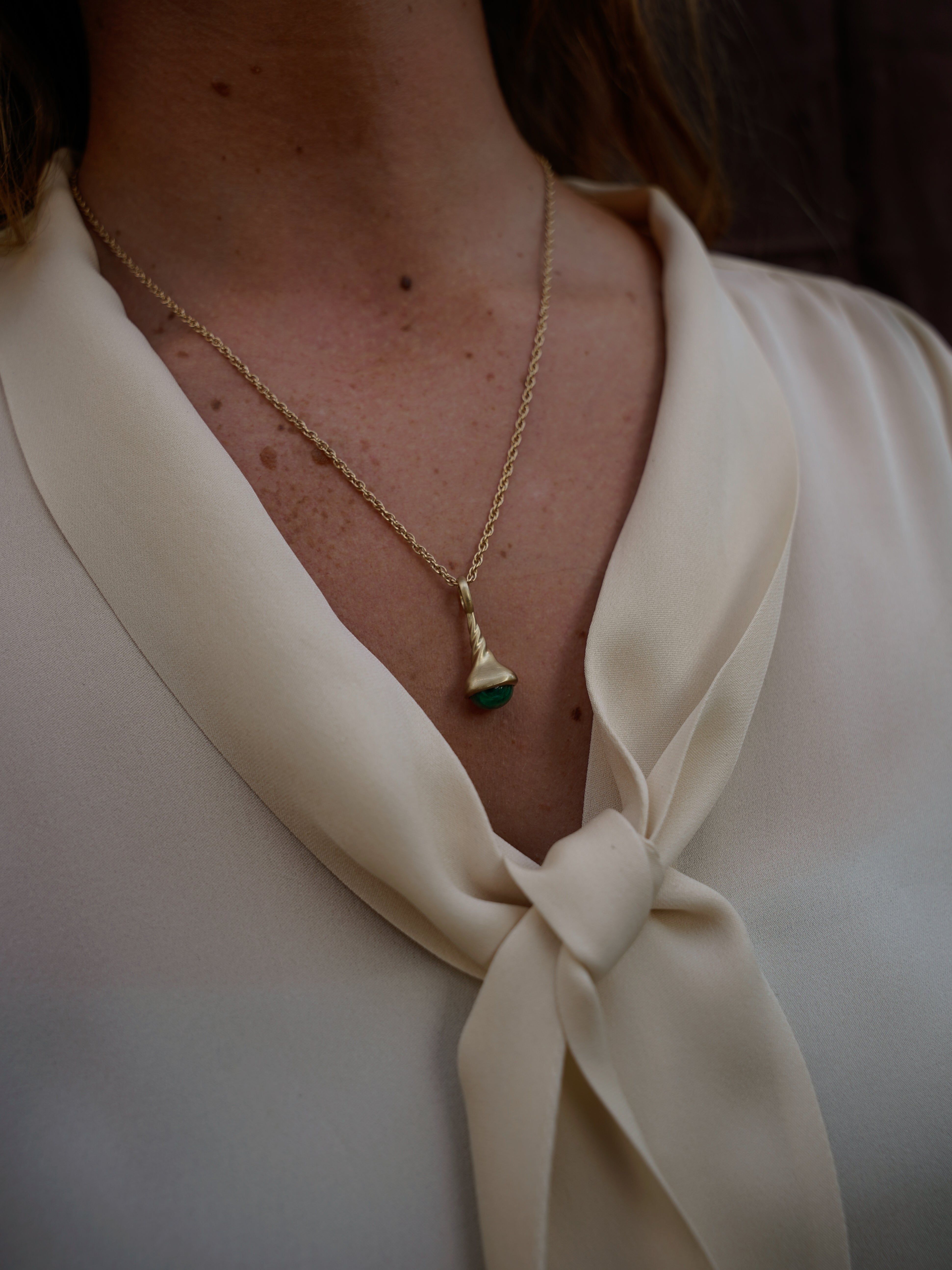 Okay Fine Gold Pendulum Charms On Model Round Emerald