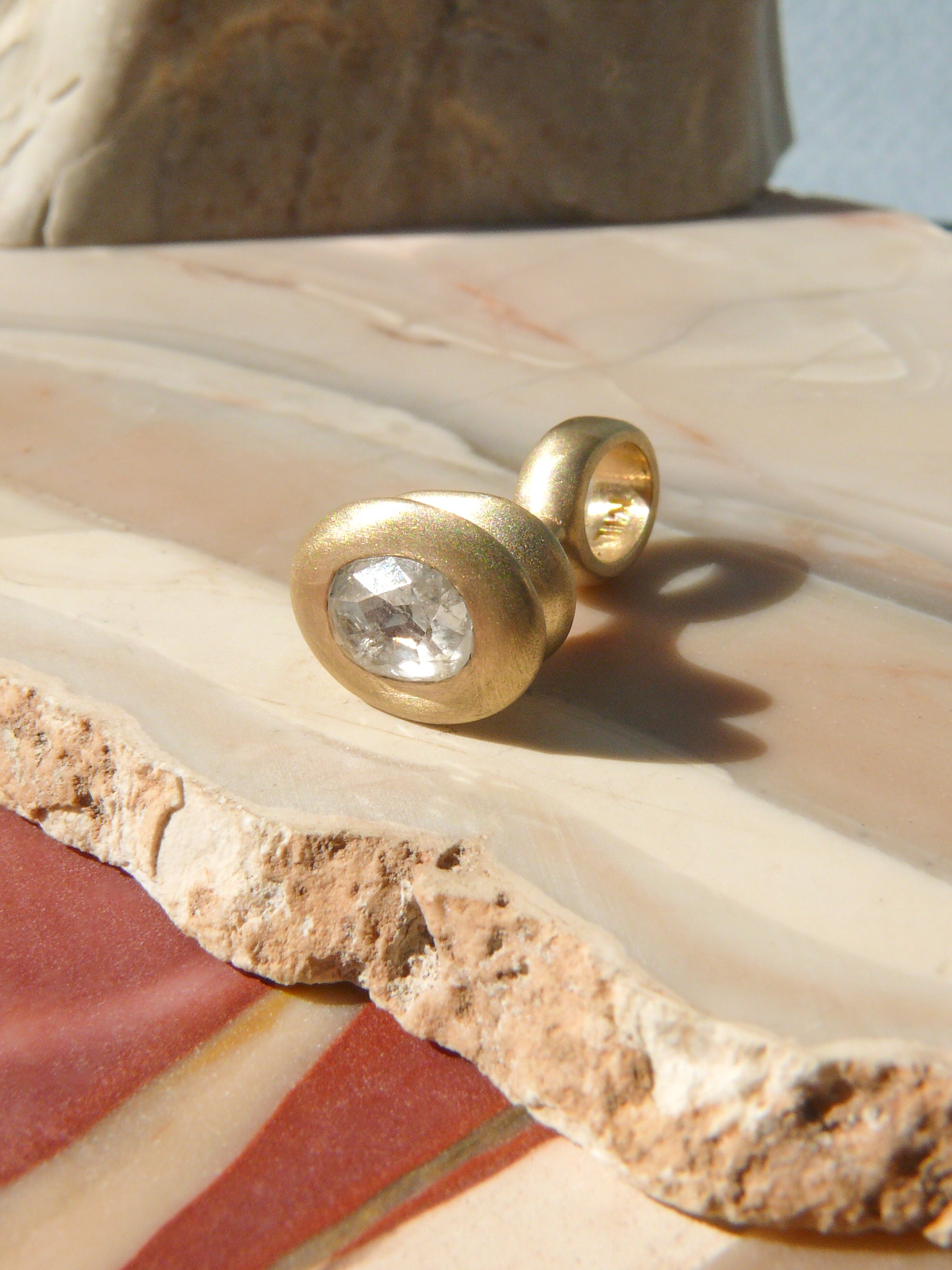 oval rose cut diamond pendulum charm no. 9 on rough jasper background
