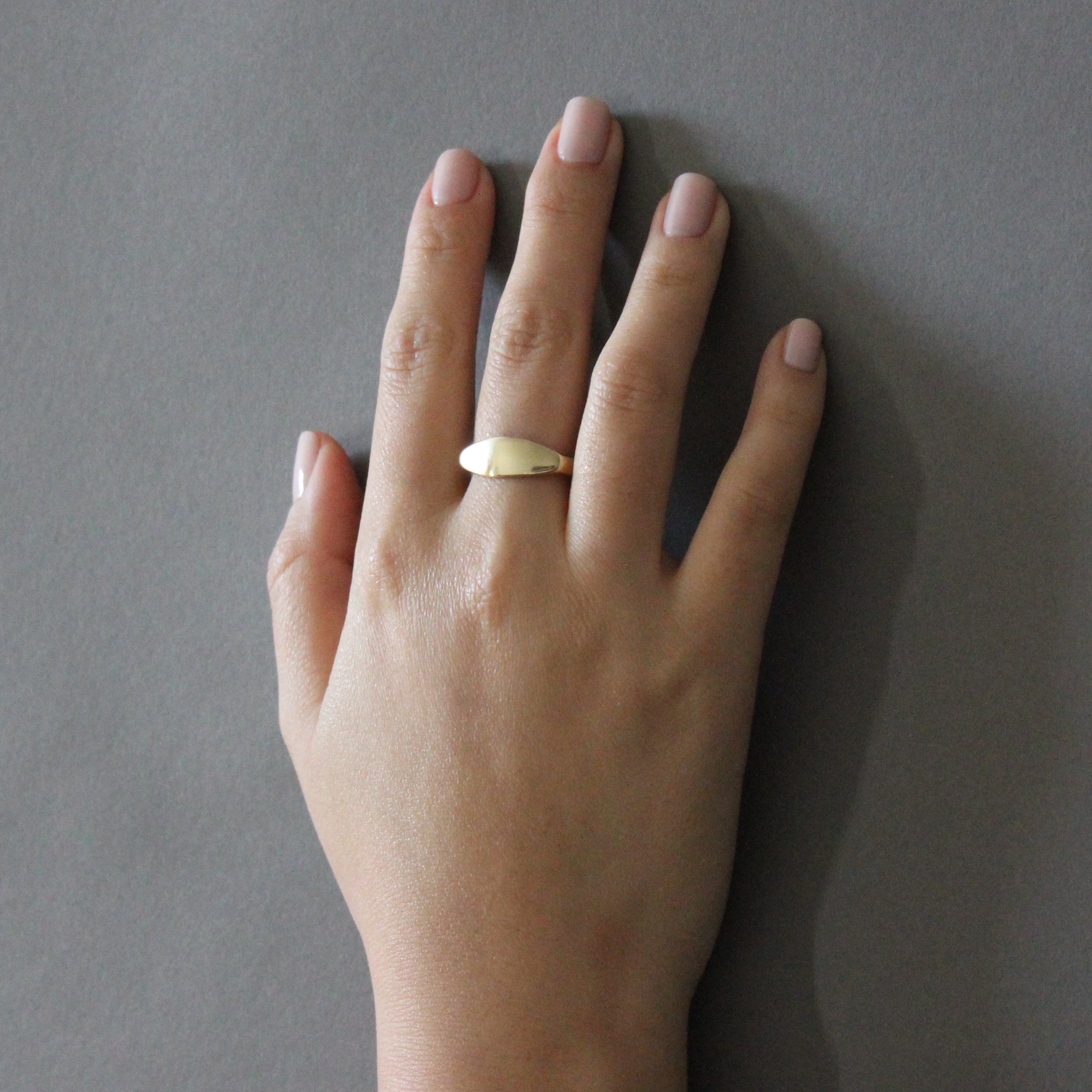 gold bandeau ring on hand 