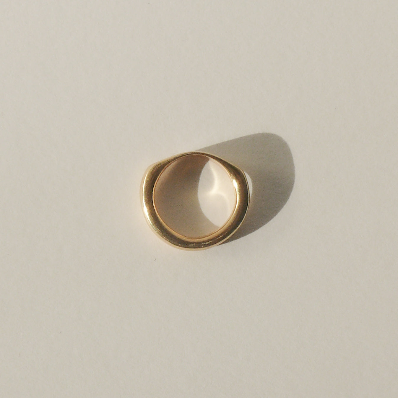 gold bandeau ring on white background