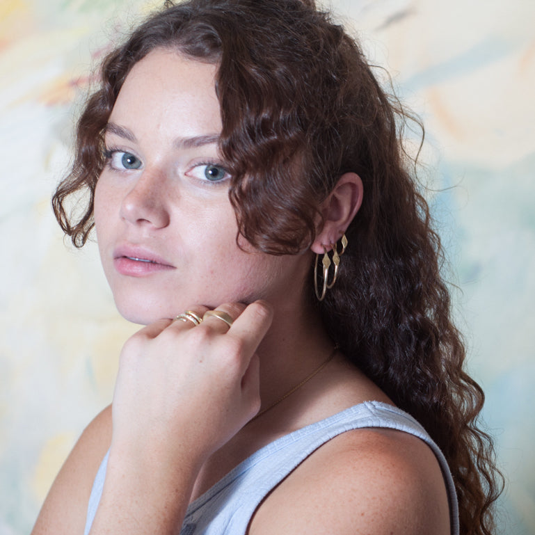 gold signet hoop earrings on model