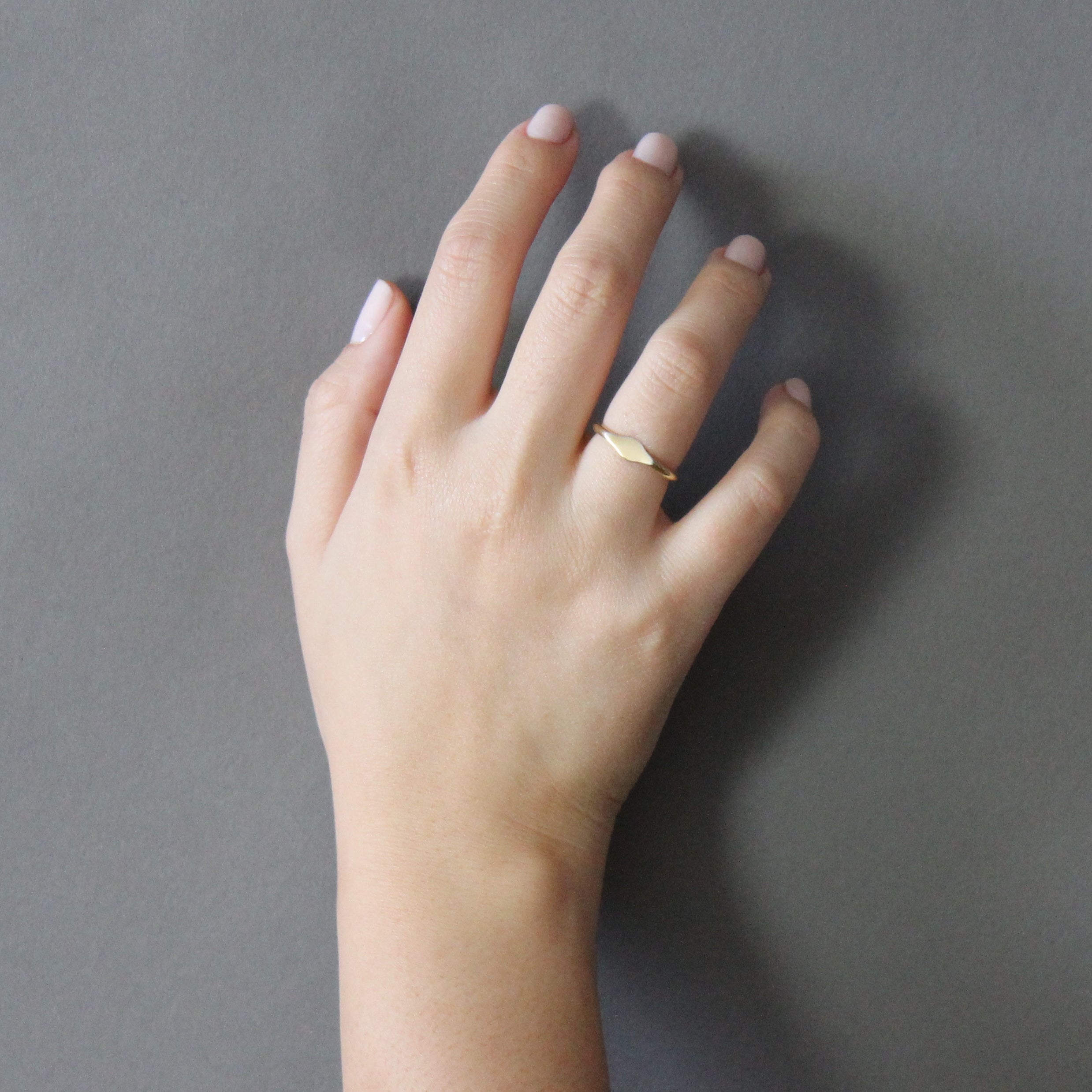 gold petite signet ring on model