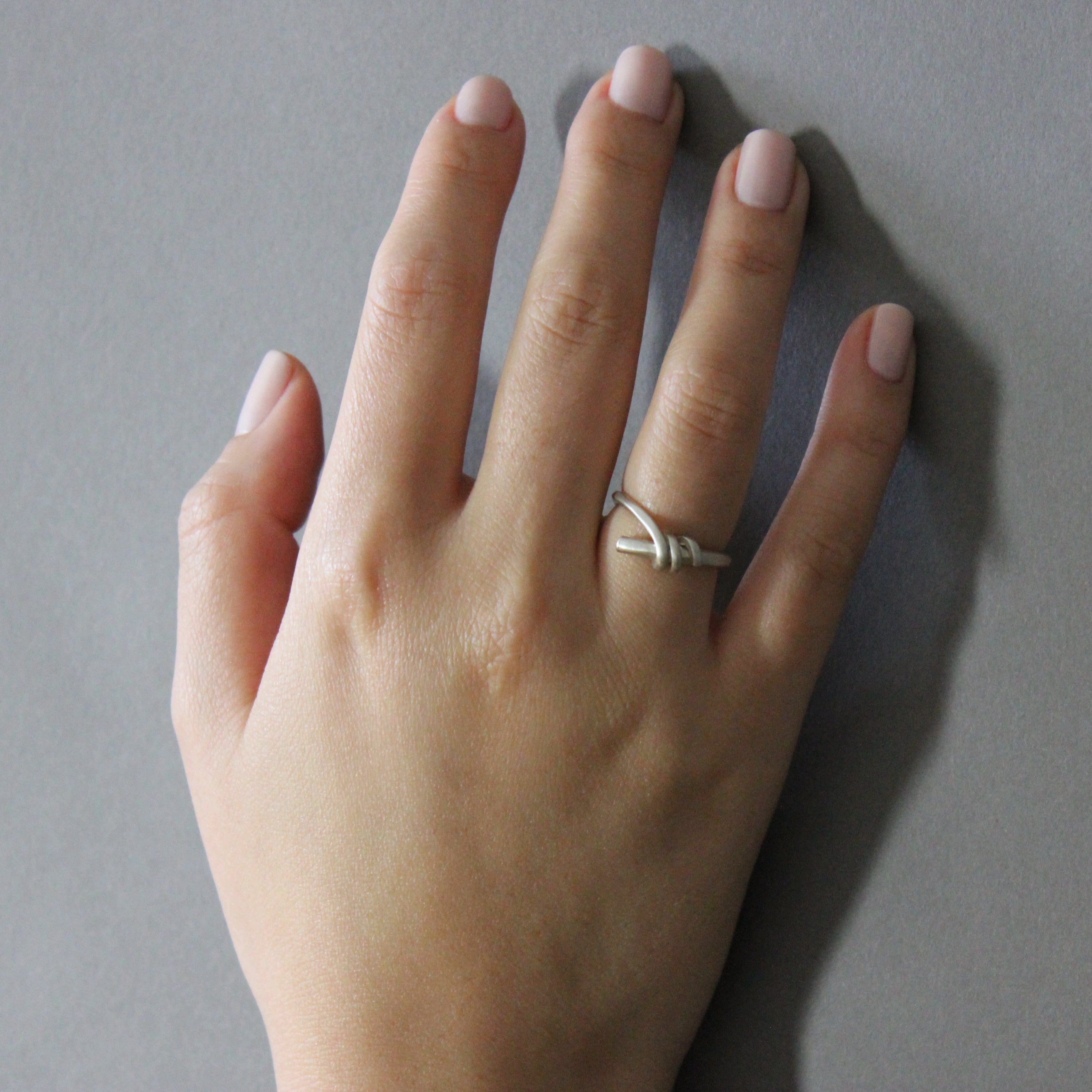 silver knot ring on model